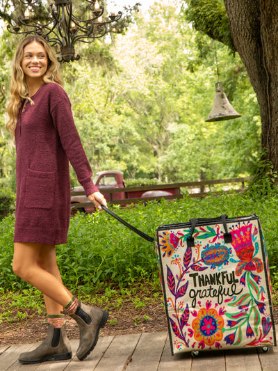 image of girl pulling rolling tote for new arrivals